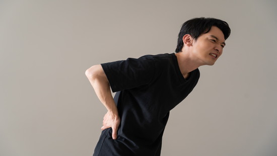 体がくの字に曲がった姿勢と腰痛